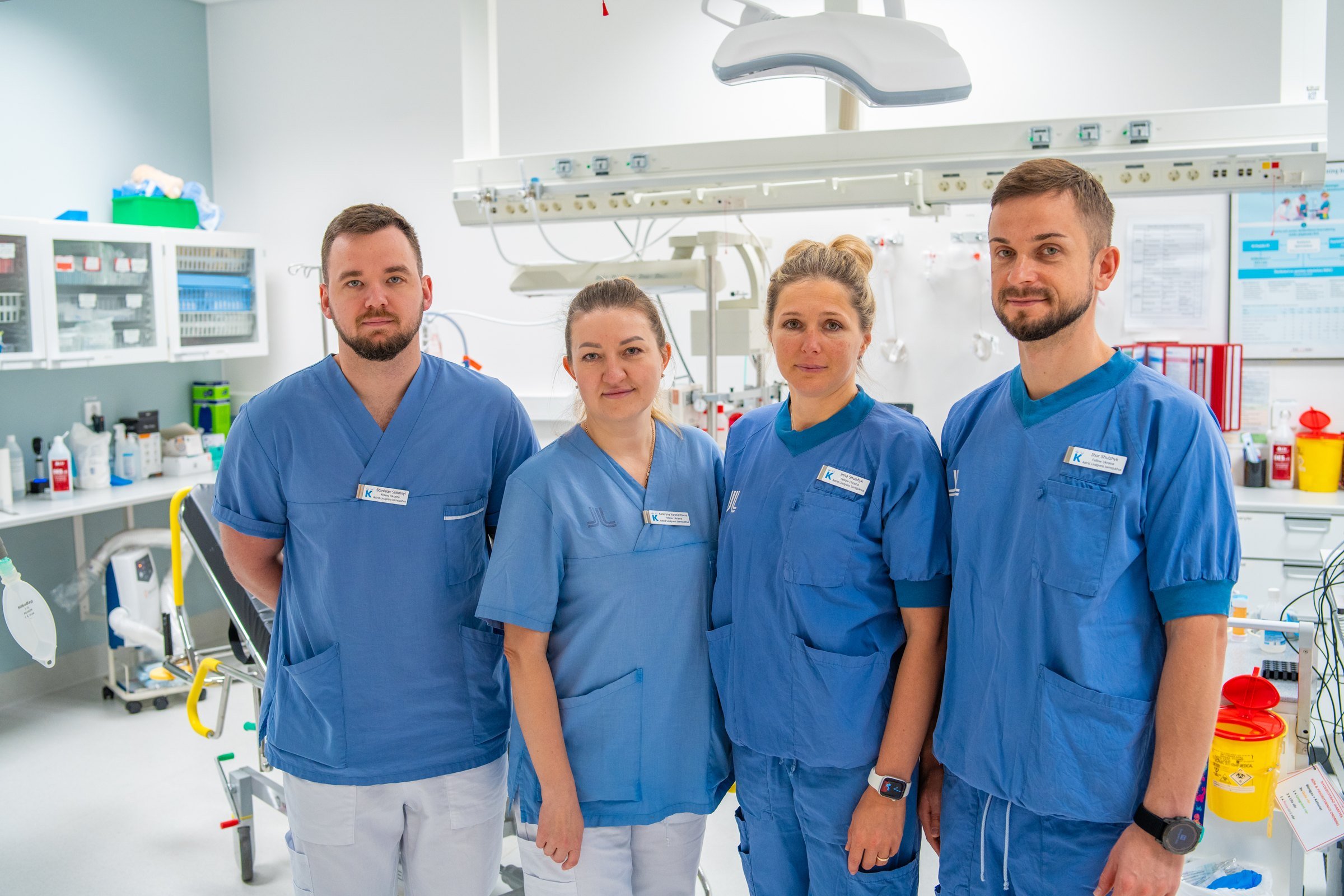 A group of doctors standing in a hospital room