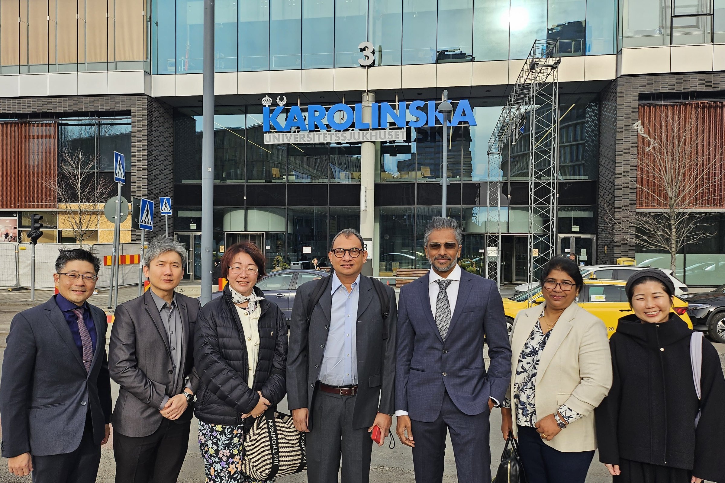 group of people from singapore woodland's health in front of Karolinska University Hospital main entrance